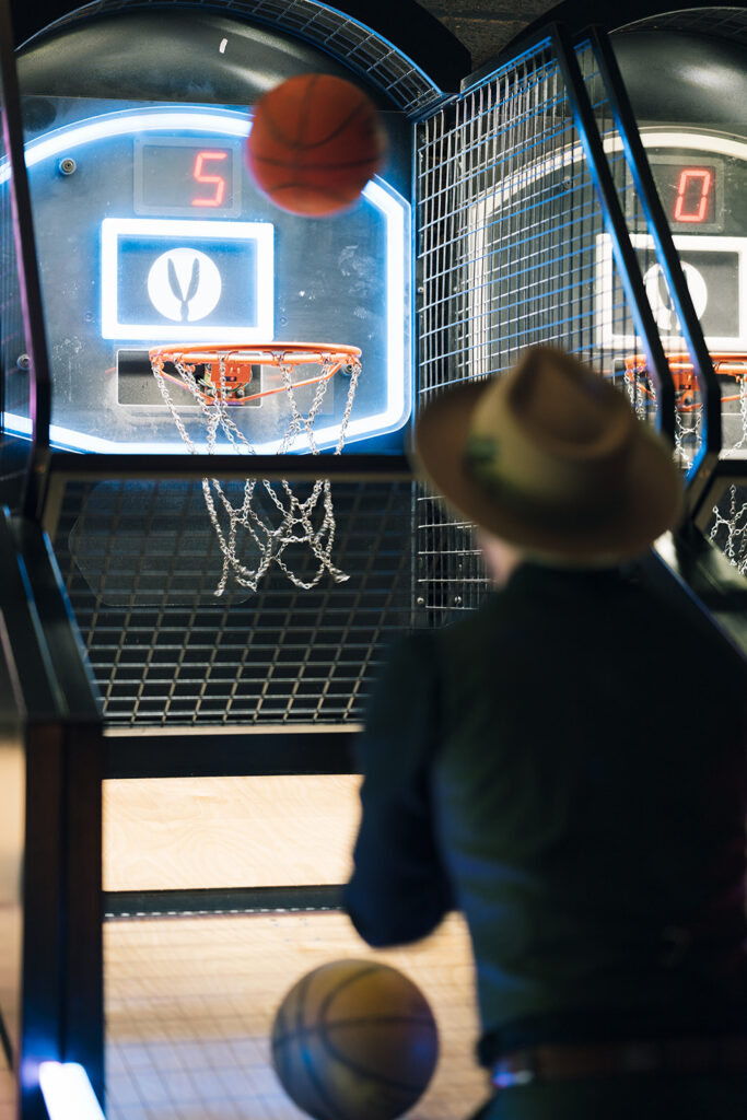Wedding guests play arcade games in the Rabbit Hole at Chasing Rabbits