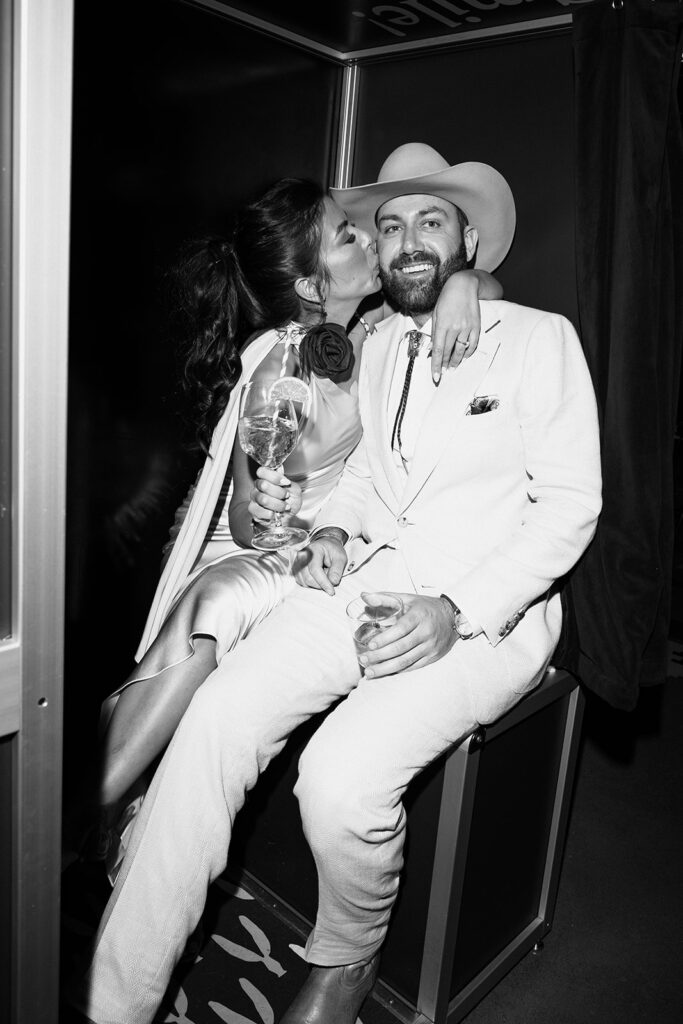 Flash photography of couple sitting in a photobooth