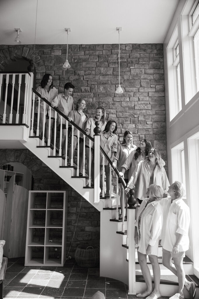 Wedding party lines up down a staircase