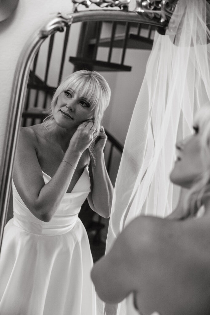 Bride gets ready in a mirror