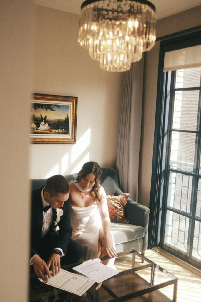Bride and groom sign marriage license in their room at The Ramble Hotel