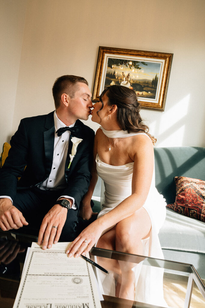 Bride and groom sign marriage license in their room at The Ramble Hotel