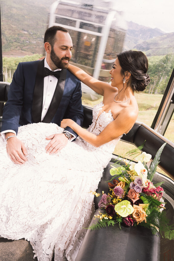 Bride and groom ride a gondola up to Vail Mountain