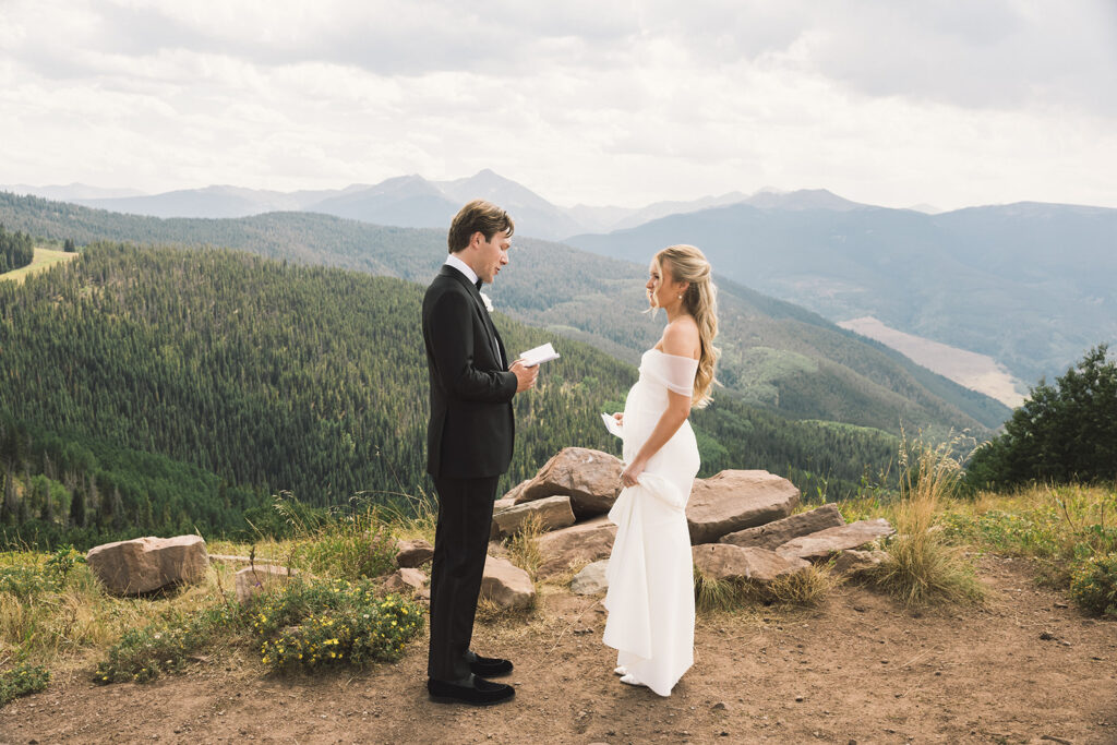 Bride and groom read private vows on a mountain in Vail, Colorado