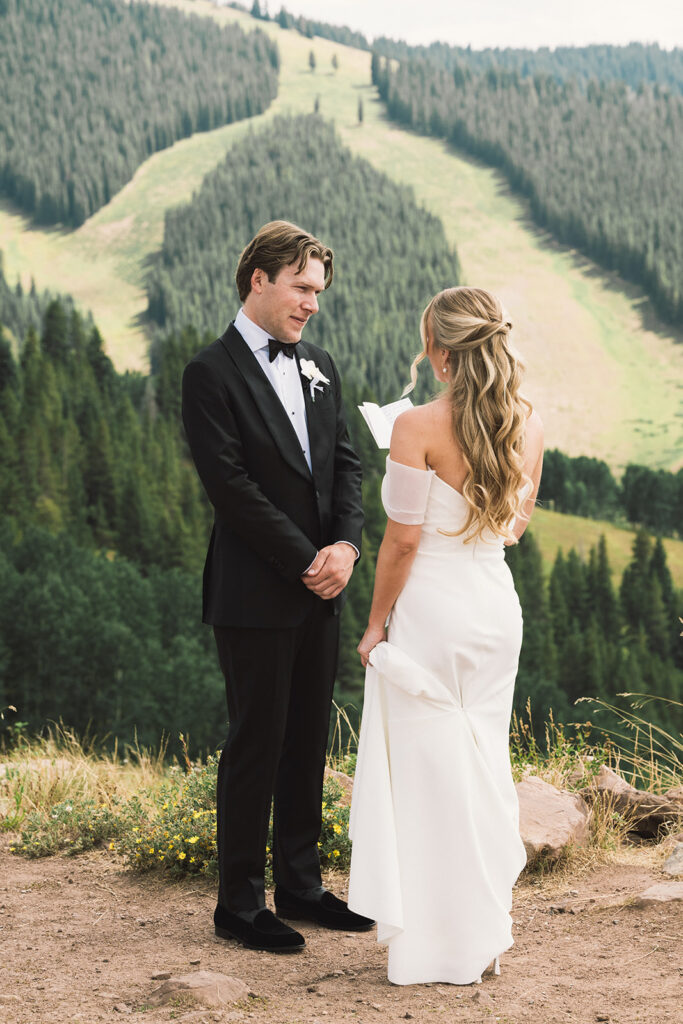 Bride and groom read private vows on a mountain in Vail, Colorado
