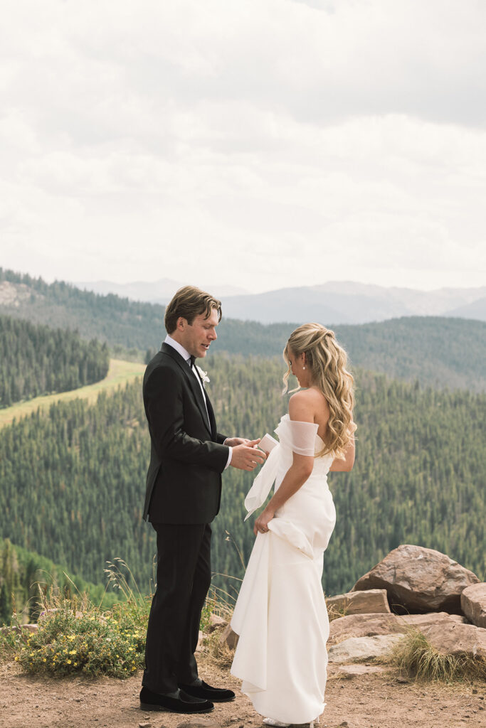 Bride and groom read private vows on a mountain in Vail, Colorado
